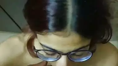Indian bikini girl in glasses gives blowjob to boyfriend